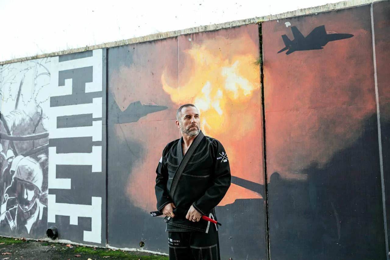 Jeff Tiegs before a mural of aircraft and fire